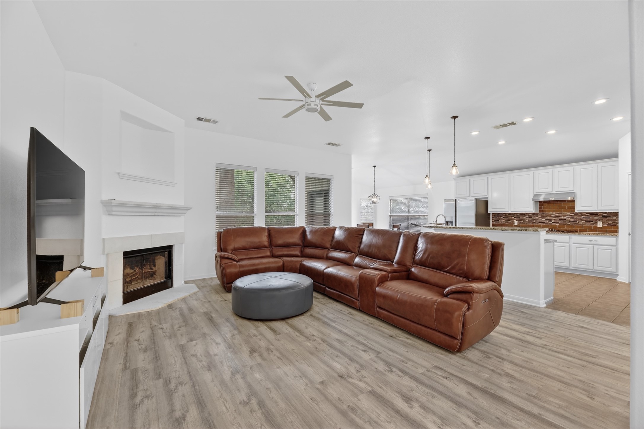 545 Manchester Lane Austin, TX 78737 - Photo 2 of 30 a living room with furniture and a fireplace