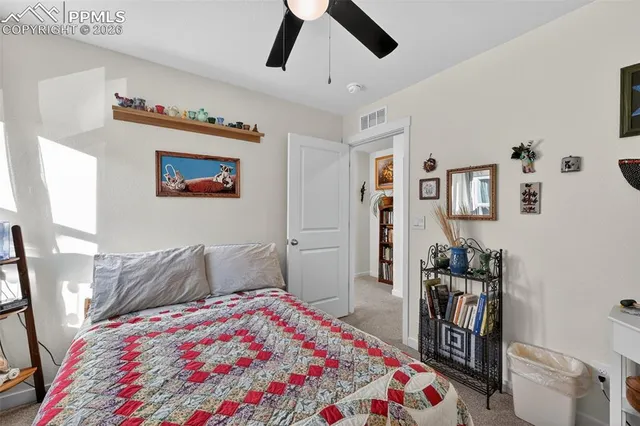 a bedroom with a bed and a bookshelf