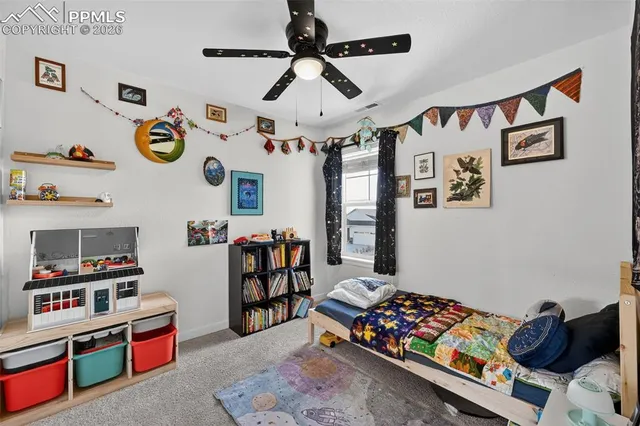 a bedroom with furniture and a book shelf