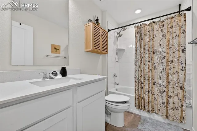 a bathroom with a sink toilet a mirror and shower