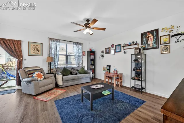 a living room with furniture and wooden floor