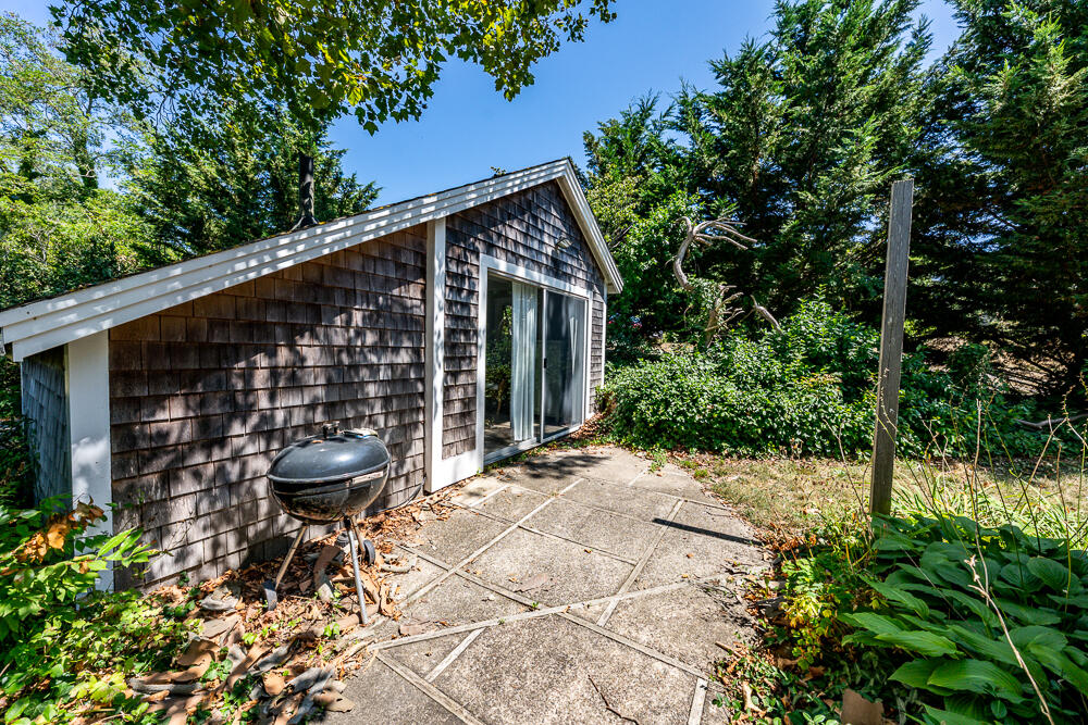 46 South Pamet Road Truro, MA 02666 - Photo 48 of 68 a backyard of a house with table and chairs