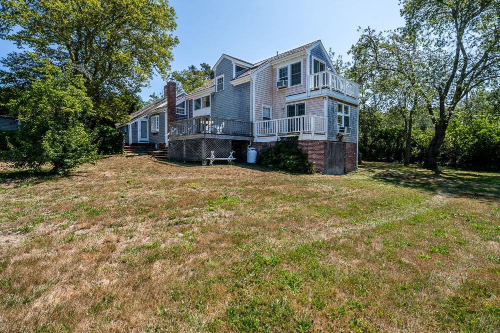 46 South Pamet Road Truro, MA 02666 - Photo 5 of 68 a view of a house next to a big yard with large trees