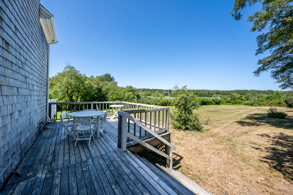 46 South Pamet Road Truro, MA 02666 - Photo 63 of 68 a view of a balcony with chair and wooden floor