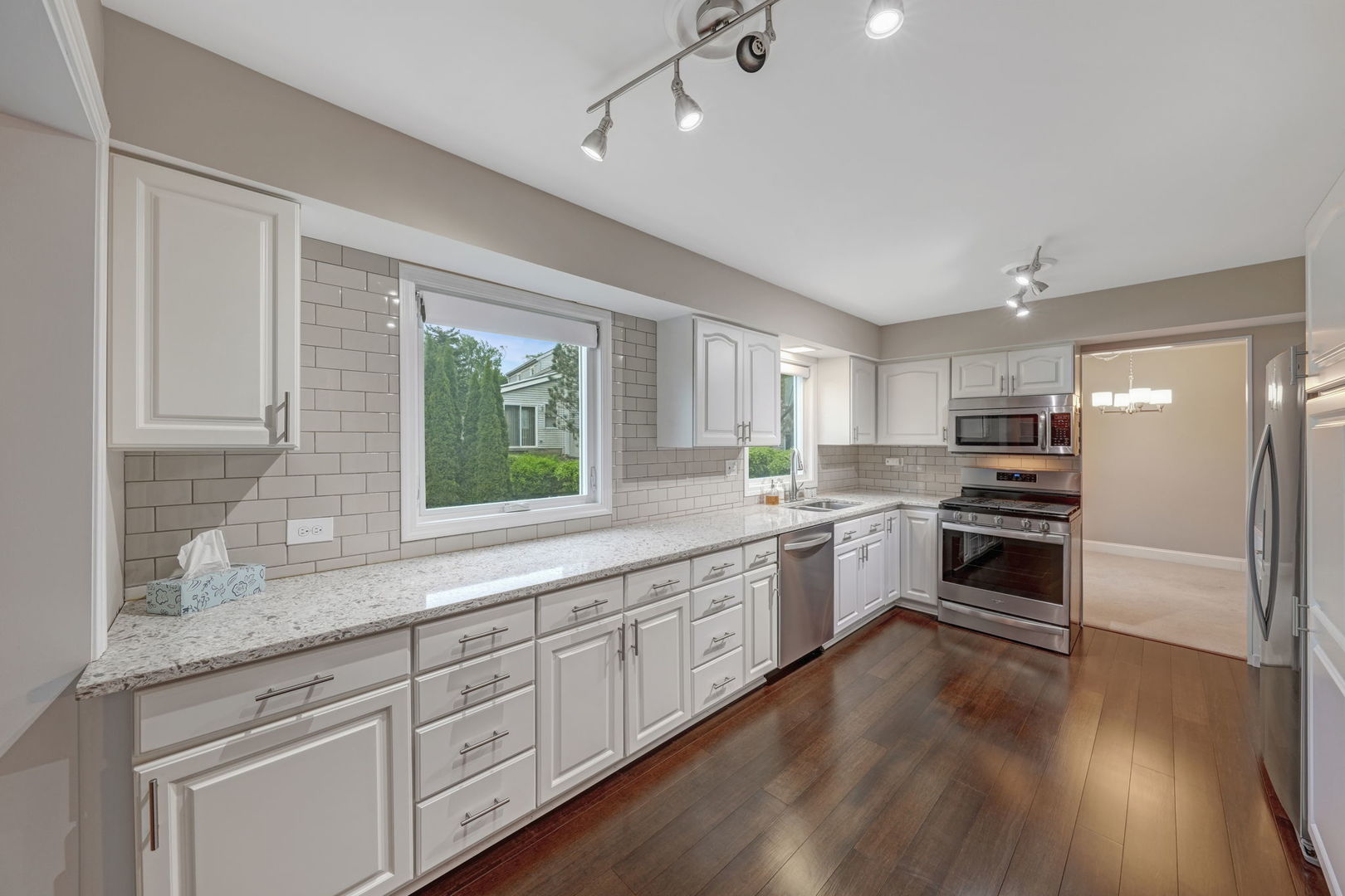 4977 Prairie Oak Road Gurnee, IL 60031 - Photo 9 of 26 a kitchen with granite countertop white cabinets and white appliances