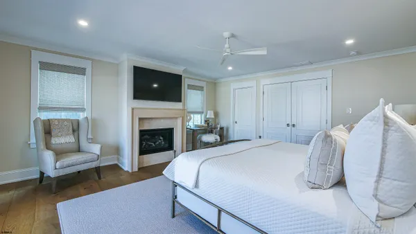 a living room with furniture and a gym machine with wooden floors