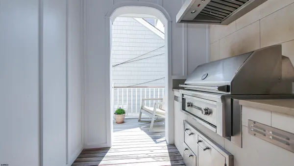 a utility room with dryer washer and a view of living room