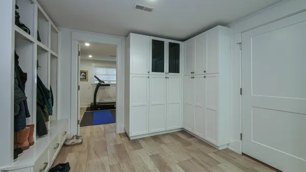 a kitchen with stainless steel appliances kitchen island granite countertop a table chairs and wooden floor