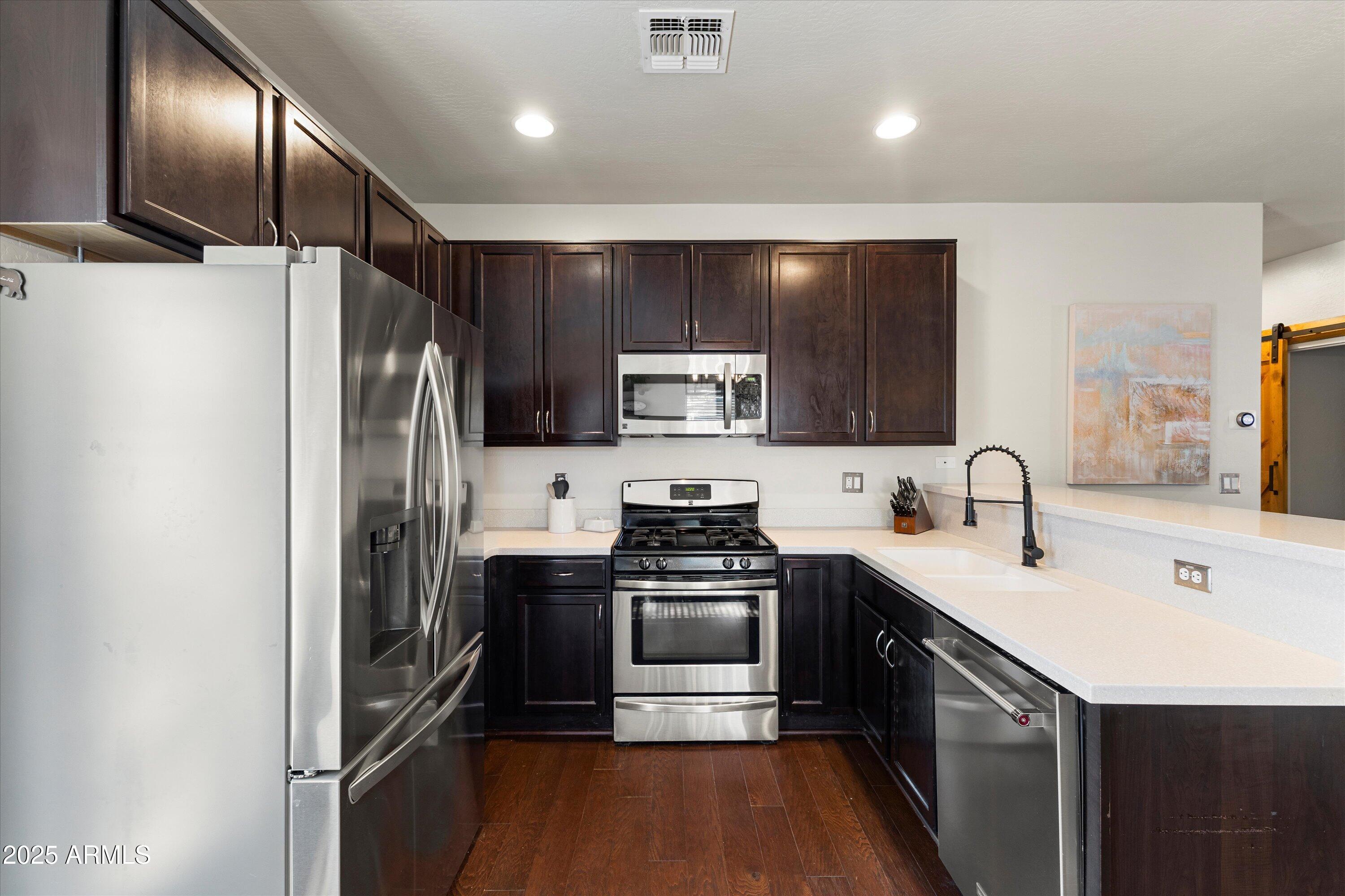 3930 North 30th Street Phoenix, AZ 85016 - Photo 14 of 40 a kitchen with a sink stainless steel appliances and cabinets