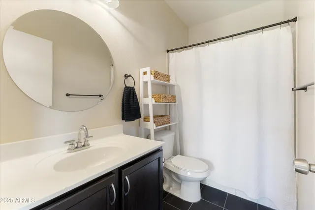 a bathroom with a sink toilet and mirror