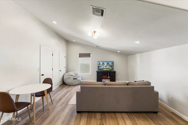 a living room with furniture a table and a potted plant