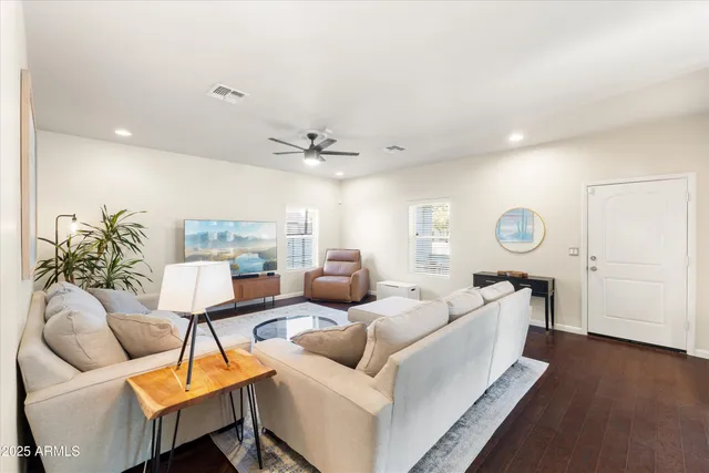a living room with furniture and a wooden floor
