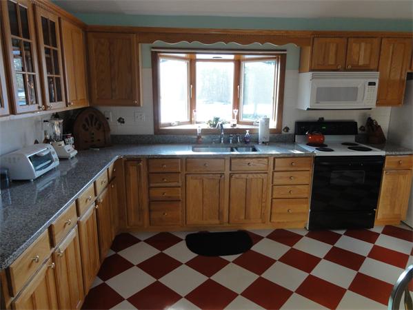 237 Andover Road Billerica, MA 01821 - Photo 5 of 24 a kitchen with a sink stove and cabinets