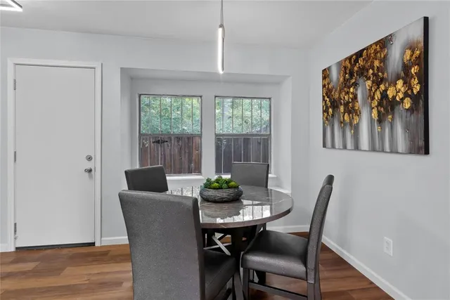 a dining room with furniture a window and wooden floor