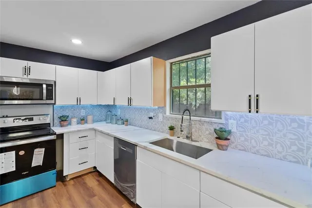 a kitchen with a sink cabinets and window