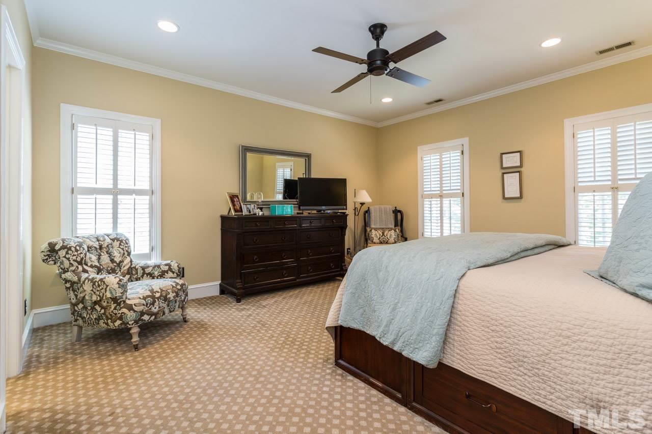 2206 Oxford Road Raleigh, NC 27608 - Photo 13 of 25 a spacious bedroom with a bed and a couch