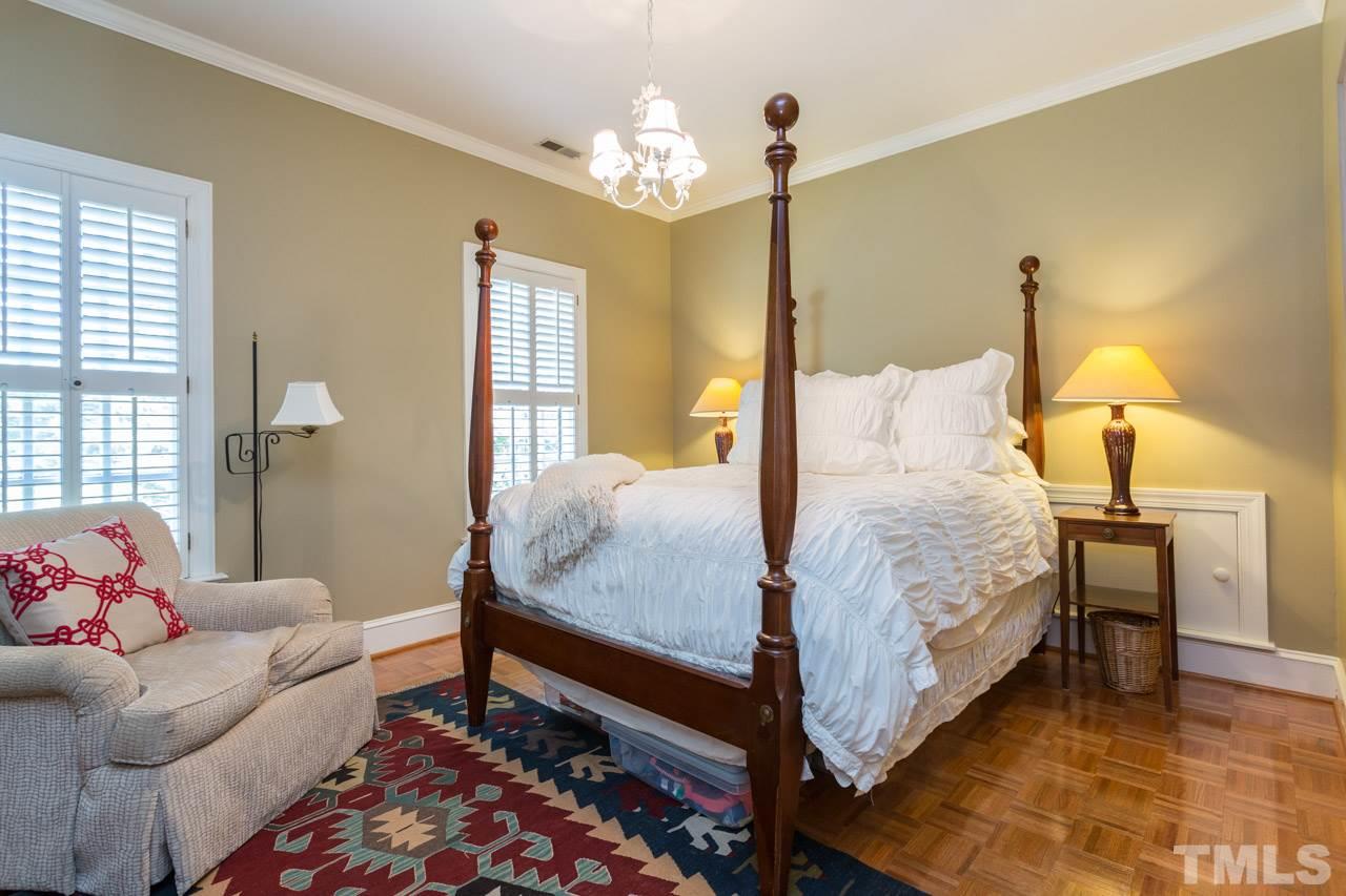 2206 Oxford Road Raleigh, NC 27608 - Photo 19 of 25 a bedroom with a bed and wooden floor
