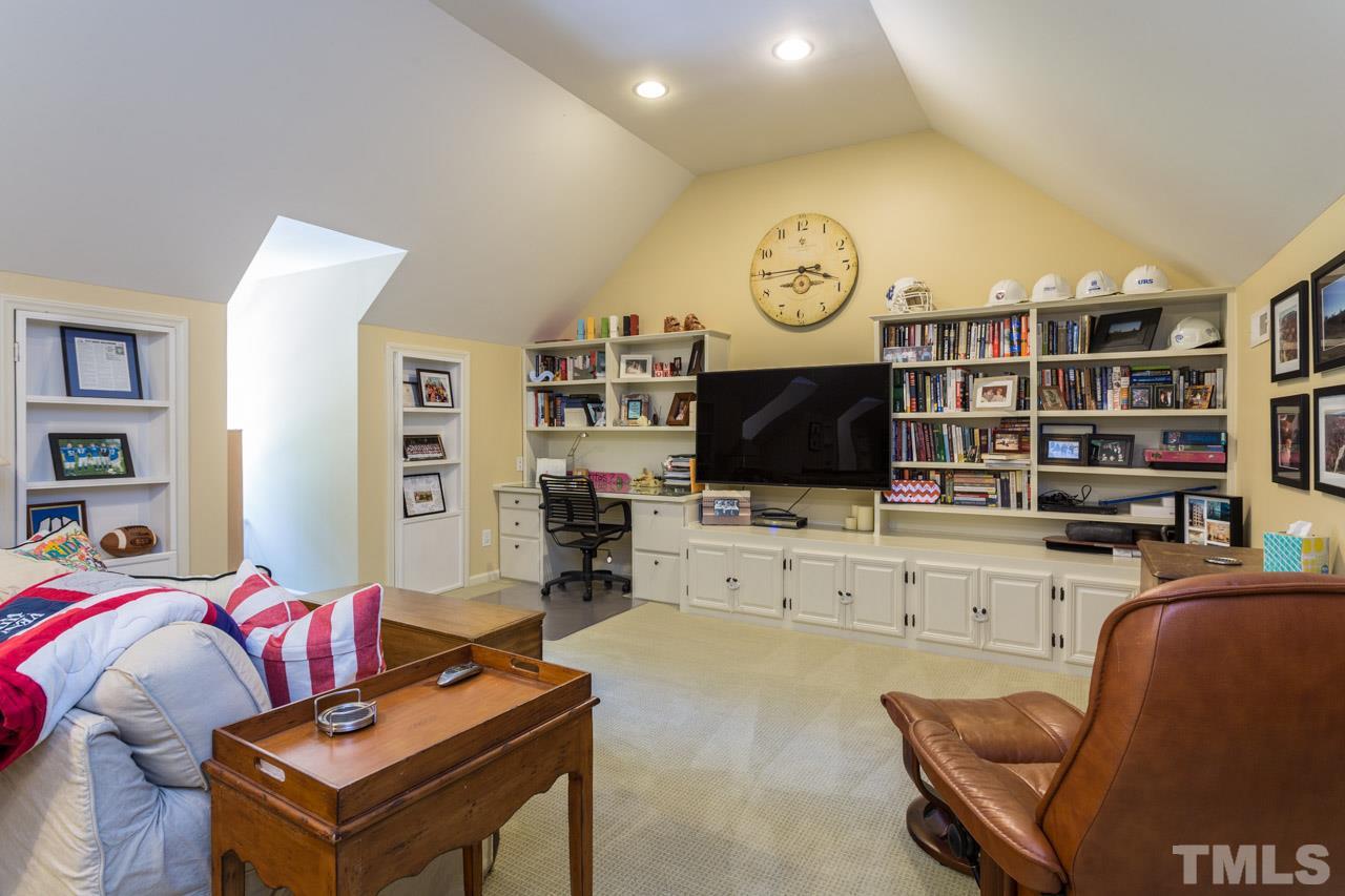 2206 Oxford Road Raleigh, NC 27608 - Photo 21 of 25 a living room with furniture cabinets and a flat screen tv