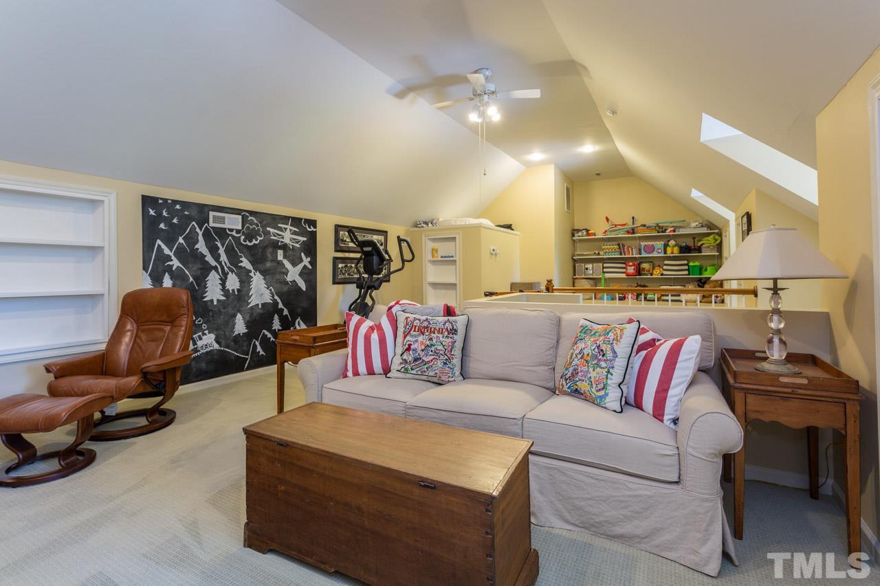 2206 Oxford Road Raleigh, NC 27608 - Photo 22 of 25 a living room with furniture gym equipment and a mirror