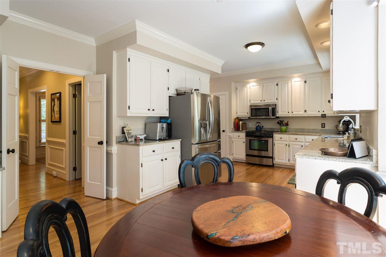 2206 Oxford Road Raleigh, NC 27608 - Photo 6 of 25 a kitchen with stainless steel appliances granite countertop a stove a refrigerator a oven a sink with island and chairs