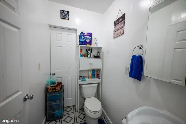 a bathroom with a toilet and a shower curtain