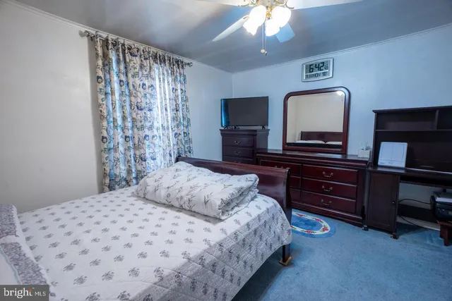 a bedroom with a bed and a television