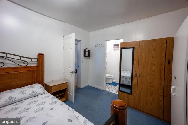 a bedroom with a bed and a couch