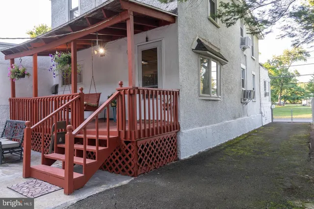 a view of a house with wooden deck and a potted plant