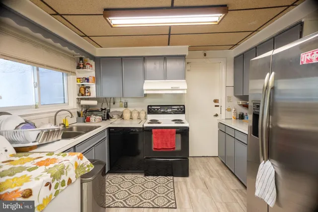 a kitchen with stainless steel appliances granite countertop a refrigerator and a sink
