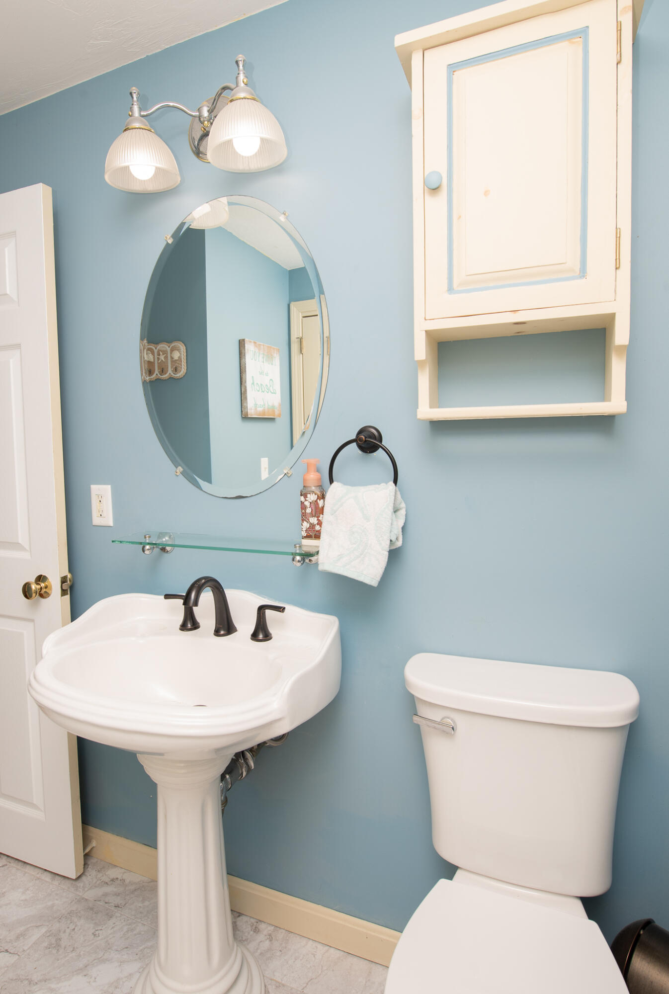 8 Yachtsman Circle Mashpee, MA 02649 - Photo 16 of 56 a bathroom with a toilet sink and mirror