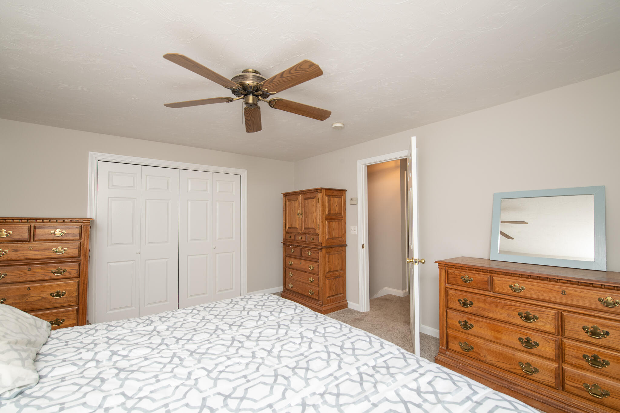 8 Yachtsman Circle Mashpee, MA 02649 - Photo 21 of 56 a bedroom with a bed and a dresser