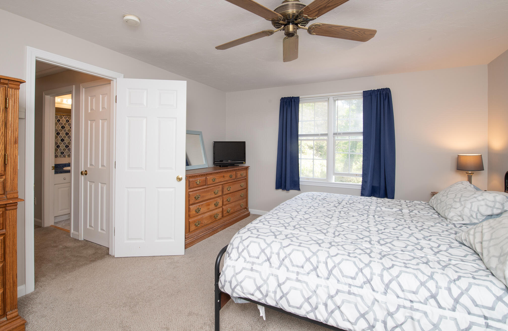 8 Yachtsman Circle Mashpee, MA 02649 - Photo 22 of 56 a bedroom with a bed and a flat screen tv