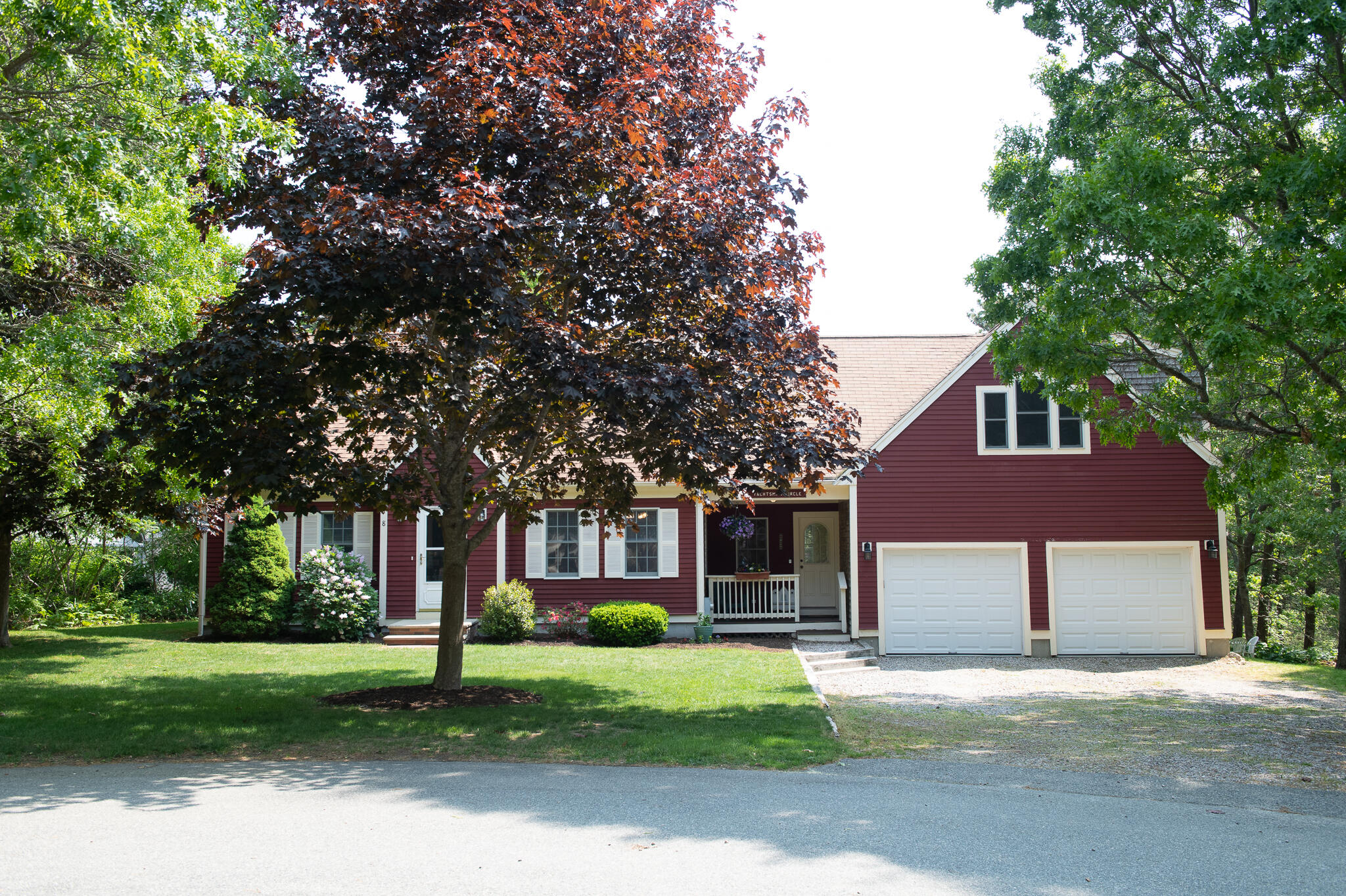 8 Yachtsman Circle Mashpee, MA 02649 - Photo 36 of 56 a front view of a house with a yard and garage
