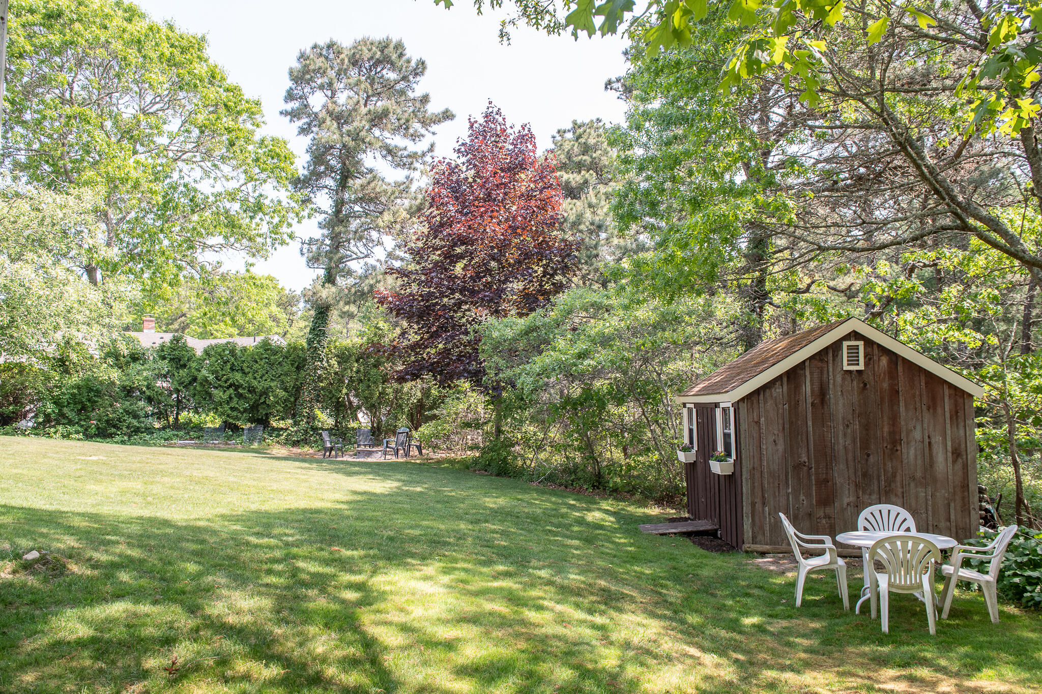 8 Yachtsman Circle Mashpee, MA 02649 - Photo 38 of 56 a view of a chair and table in backyard of the house