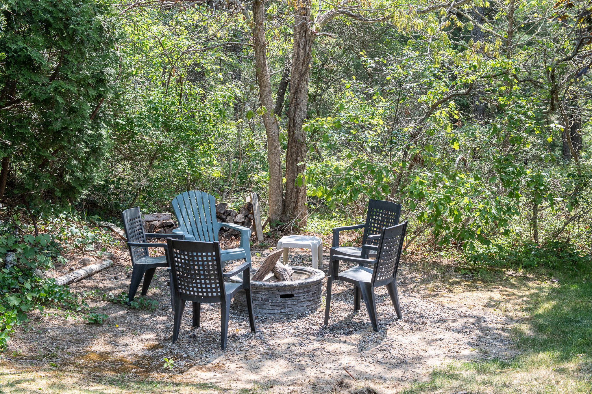 8 Yachtsman Circle Mashpee, MA 02649 - Photo 44 of 56 a view of a chairs and table in the backyard