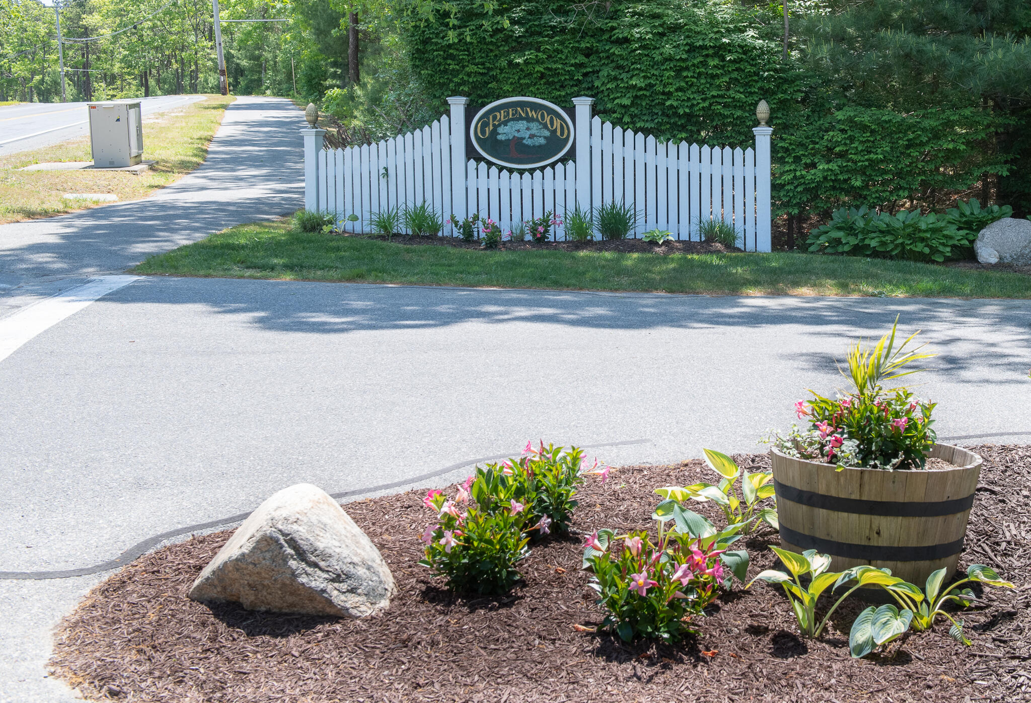 8 Yachtsman Circle Mashpee, MA 02649 - Photo 49 of 56 a front view of a house with a yard and fountain