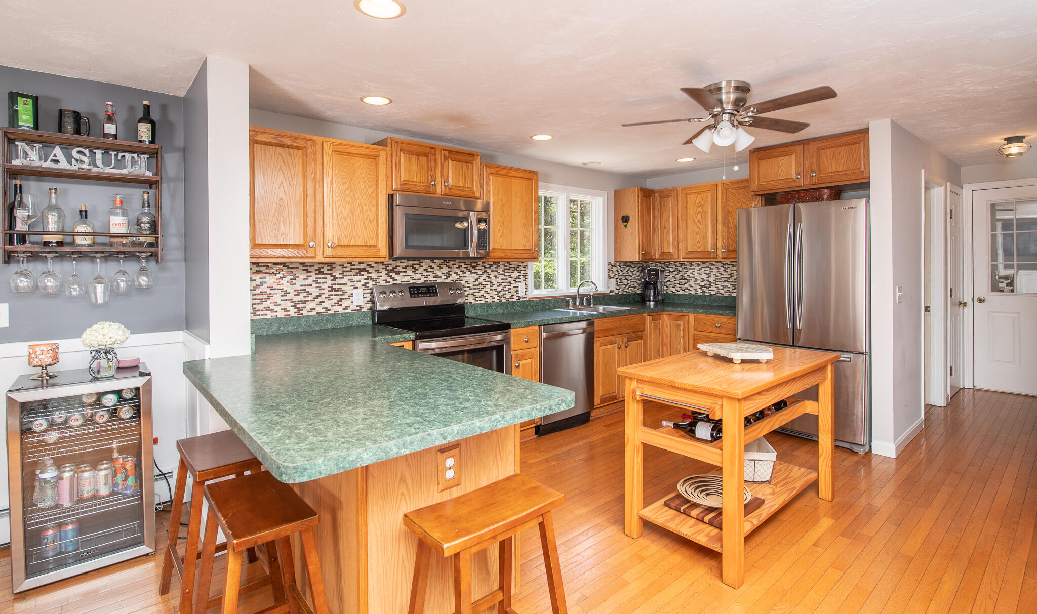 8 Yachtsman Circle Mashpee, MA 02649 - Photo 9 of 56 a kitchen with stainless steel appliances granite countertop a stove oven and a dining table