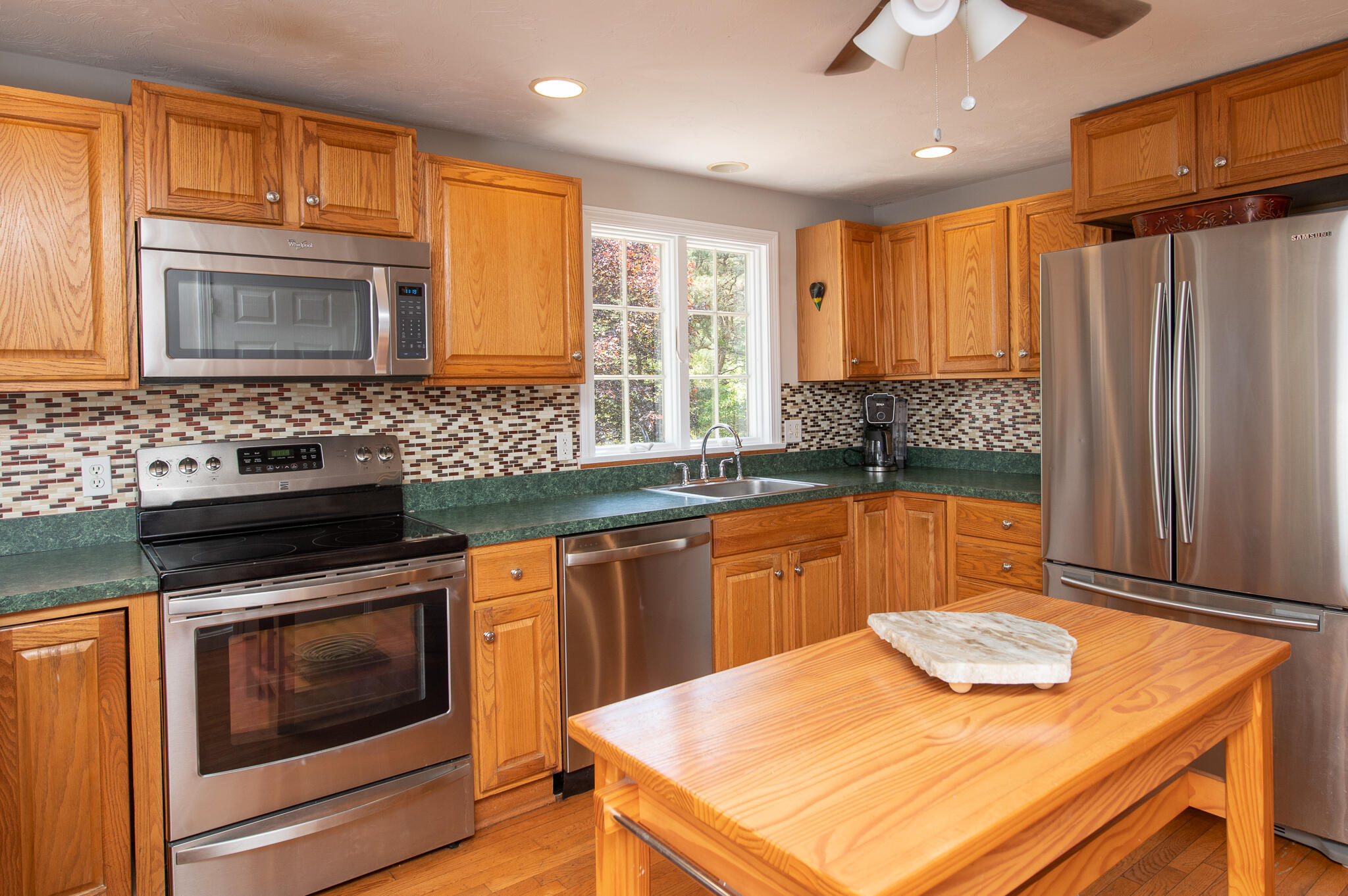8 Yachtsman Circle Mashpee, MA 02649 - Photo 10 of 56 a kitchen with stainless steel appliances granite countertop a sink stove and refrigerator