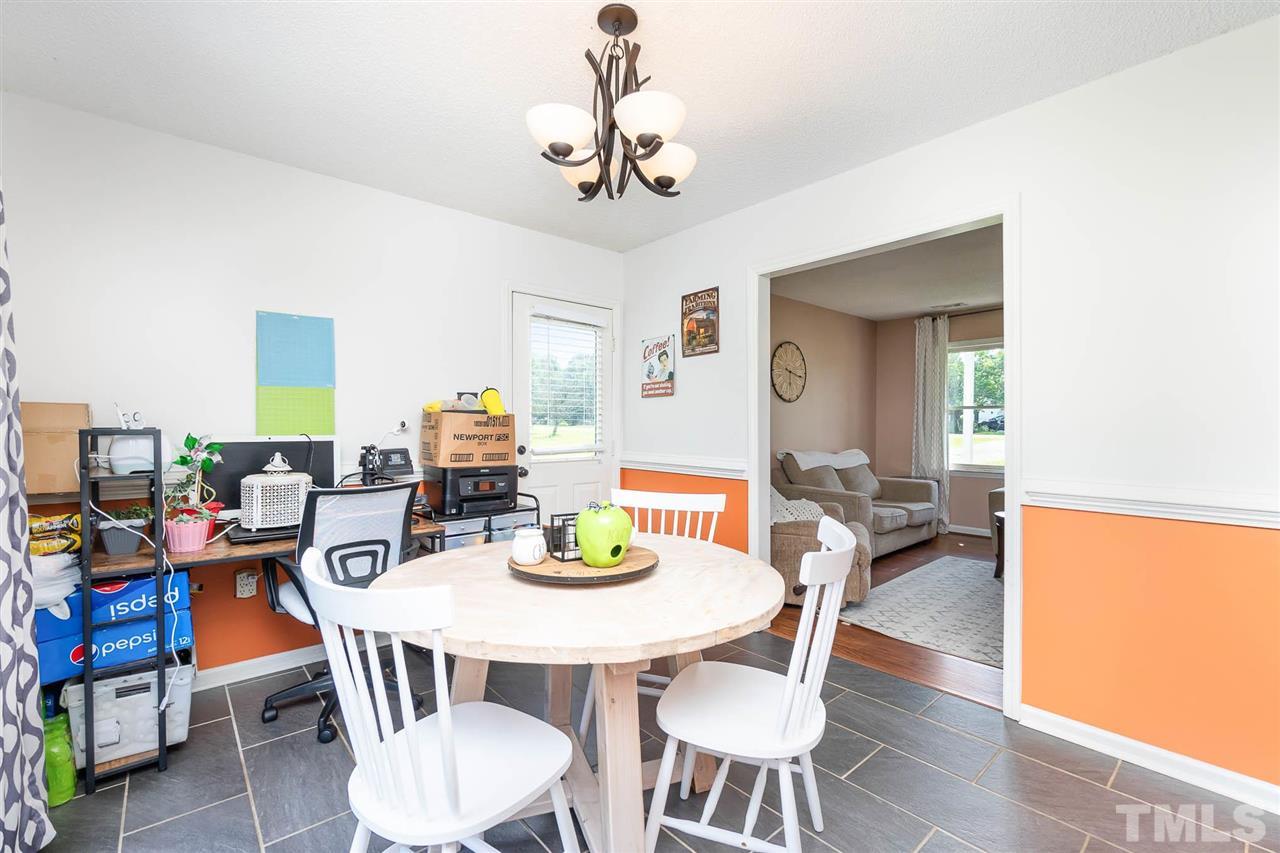 321 Jeribec Drive Willow Spring, NC 27592 - Photo 16 of 21 a dining room with furniture a chandelier and wooden floor