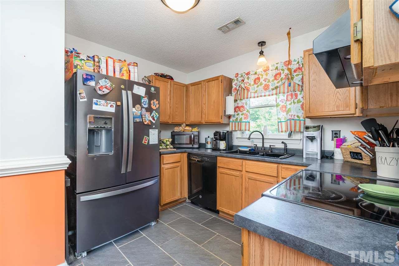 321 Jeribec Drive Willow Spring, NC 27592 - Photo 17 of 21 a kitchen with stainless steel appliances granite countertop a refrigerator and a sink