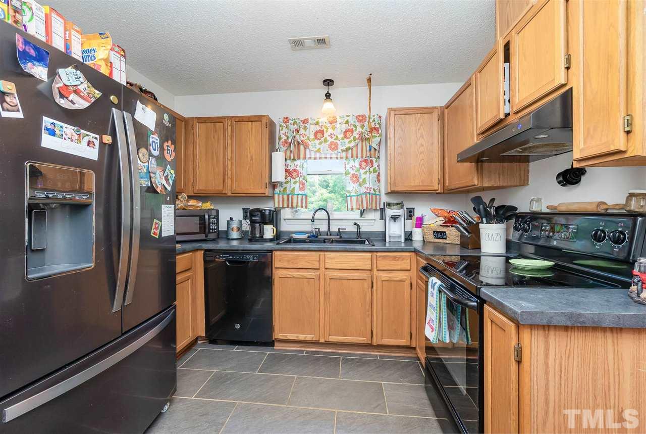 321 Jeribec Drive Willow Spring, NC 27592 - Photo 18 of 21 a kitchen with stainless steel appliances granite countertop a sink and cabinets