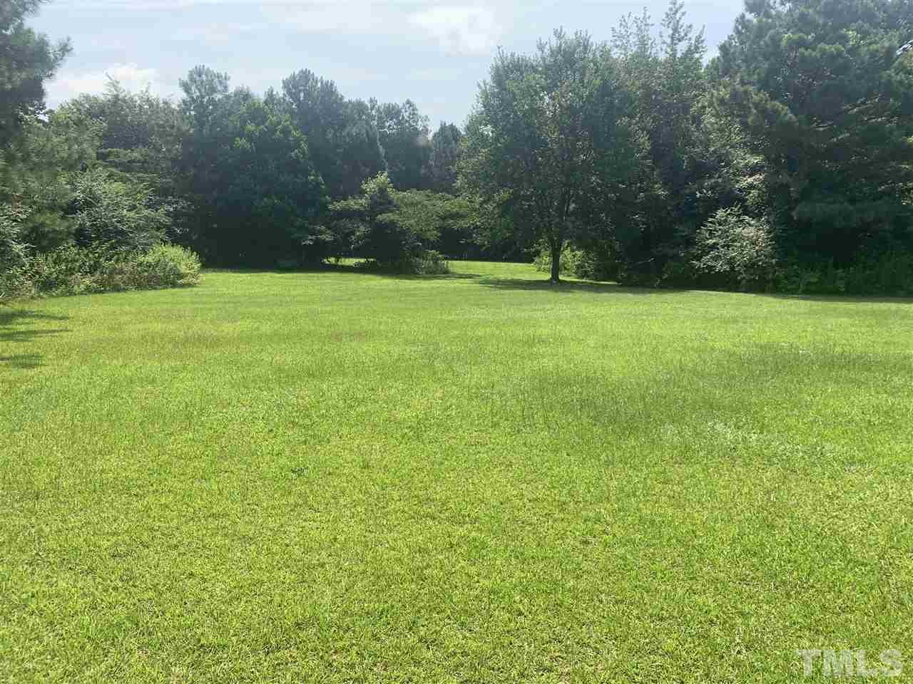 321 Jeribec Drive Willow Spring, NC 27592 - Photo 5 of 21 a view of green field with trees in the background