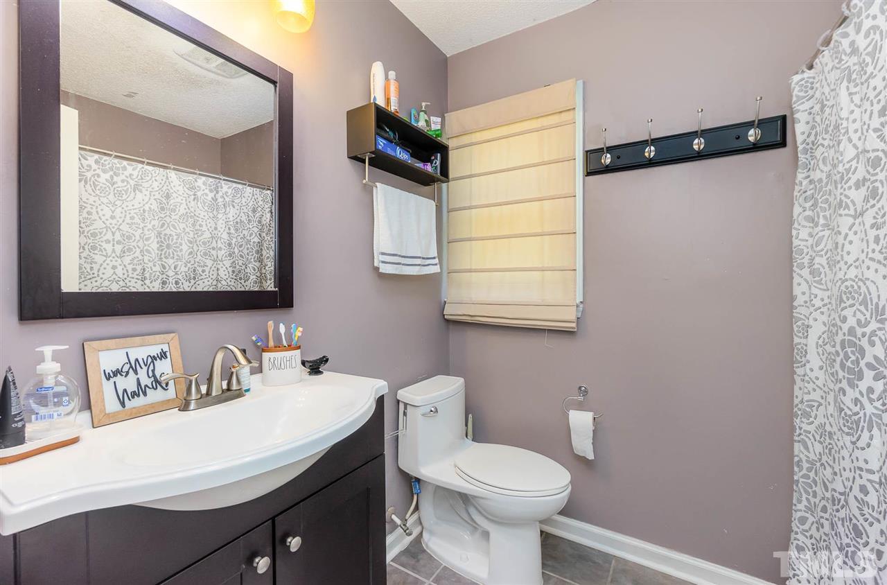 321 Jeribec Drive Willow Spring, NC 27592 - Photo 10 of 21 a bathroom with a sink and a mirror