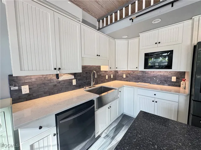 a kitchen with kitchen island a stove and a refrigerator
