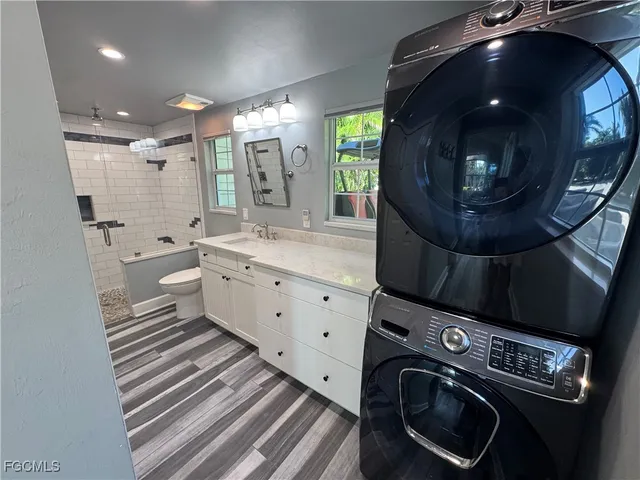 a spacious bathroom with a double vanity sink a mirror and a shower