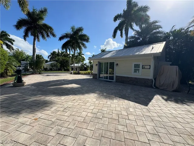 a view of a backyard with a table and chairs