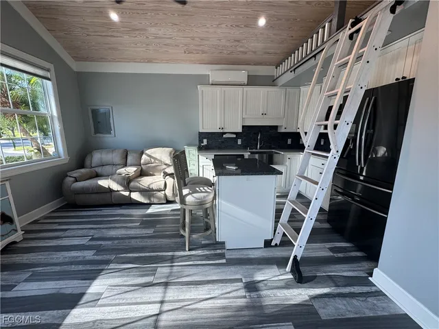 a kitchen with granite countertop a stove and a refrigerator