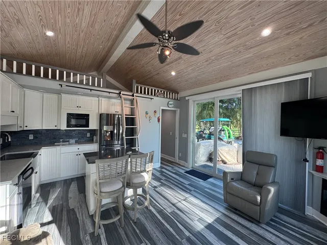 a living room with furniture tv and a fireplace