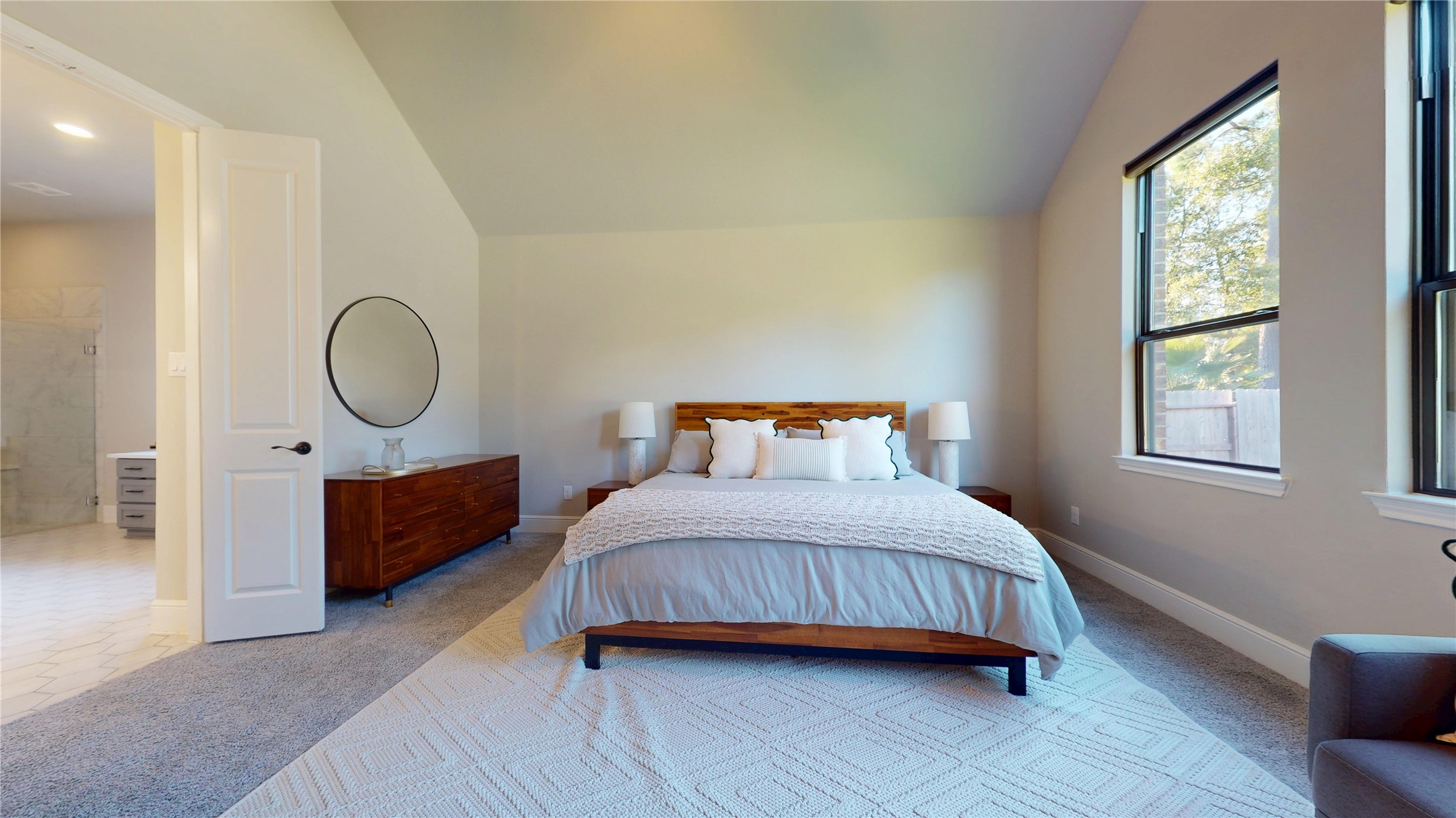 8305 Greenleaf Ridge Way Conroe, TX 77385 - Photo 11 of 33 a bedroom with a bed a mirror and a window