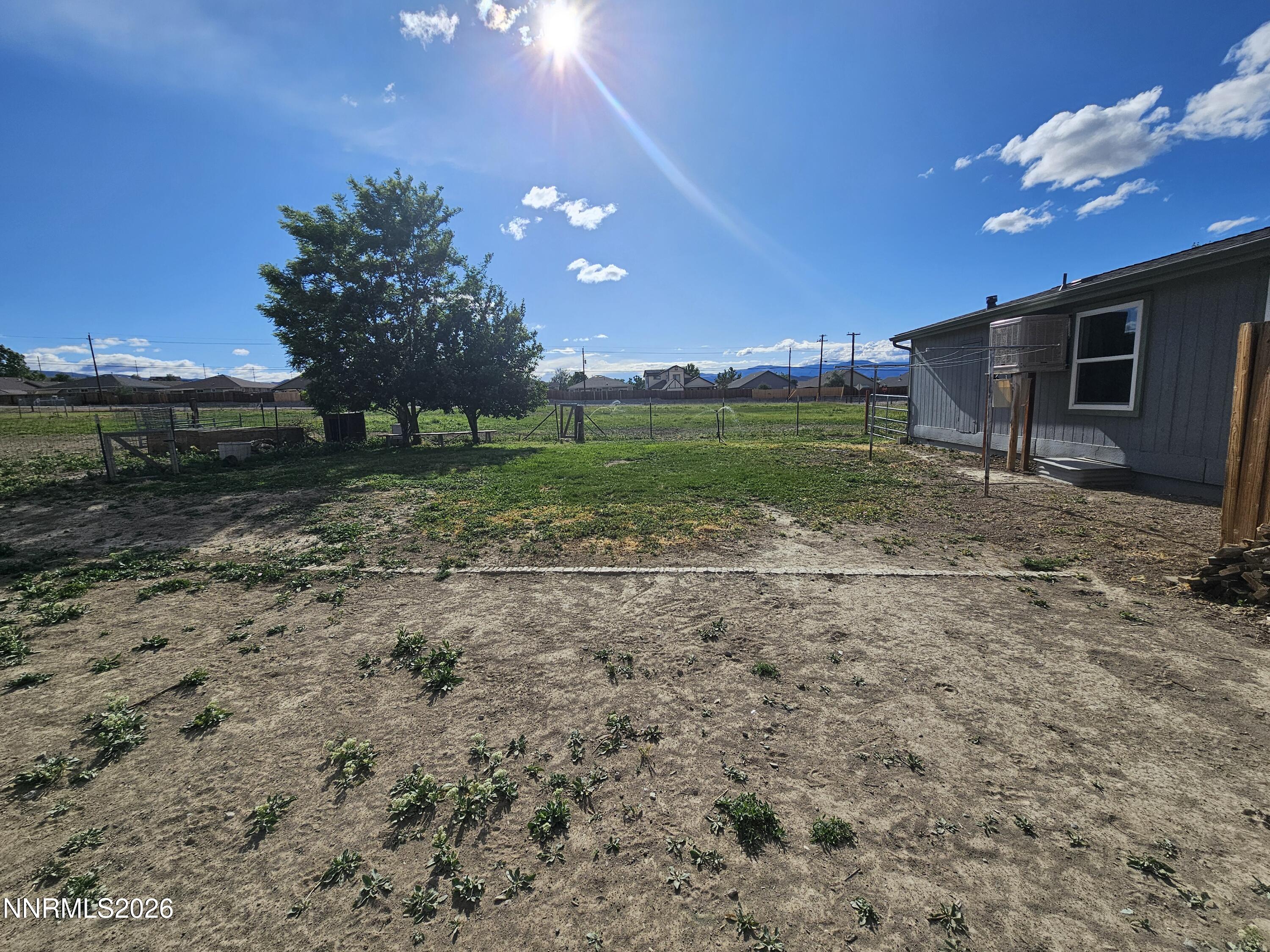1125 Rancho Road Fernley, NV 89408 - Photo 40 of 47 a view of a house with backyard and a tree